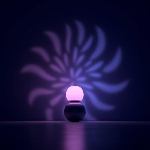 Lámpara de diseño con proyecciones de luz geométricas sobre una pared oscura